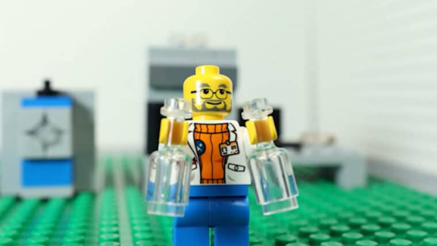 a lego character scientist holding two beakers