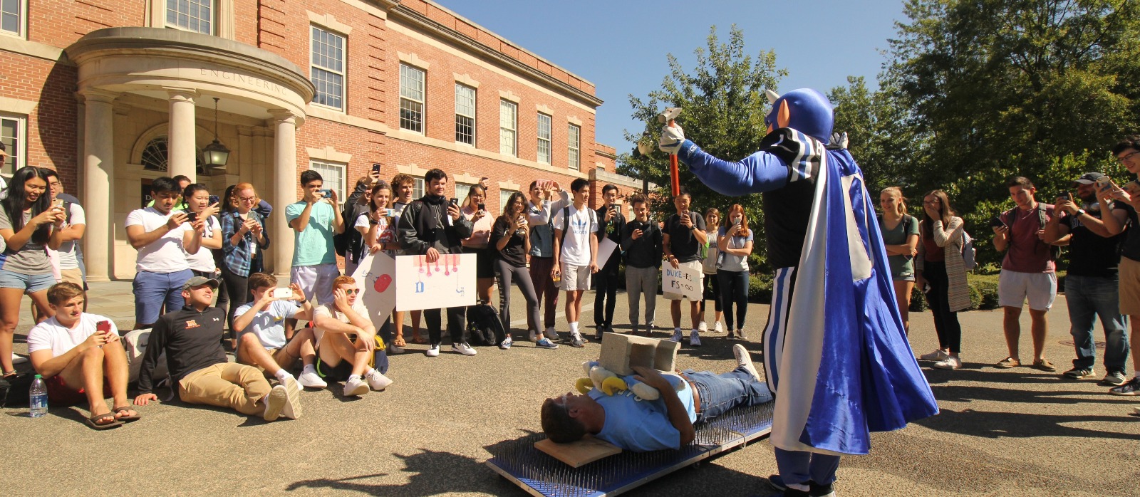 Professor David Schaad demonstrates force per inch with help from Duke mascot
