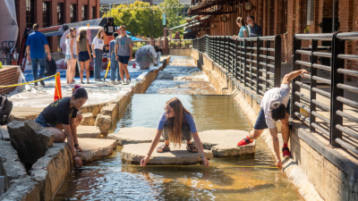 students measure water flows in downtown Durham