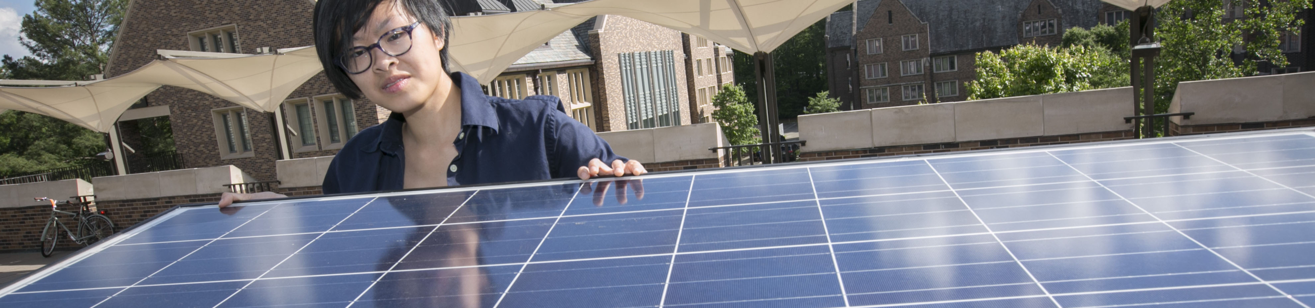 Duke Engineering student installing a solar panel on West Campus