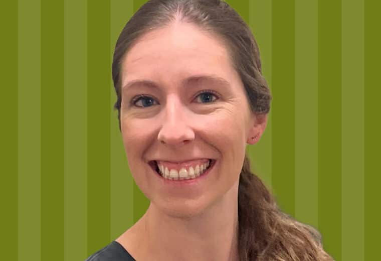 Nicole Rockey smiling in front of a striped green background