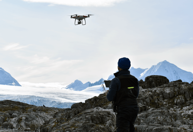 a person flying a drone in antarctica