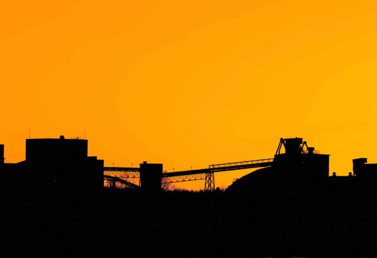 Industrial cement plant silhouette during sunset